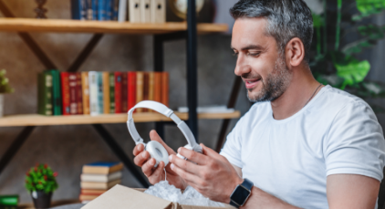 Man looking at a pair of headphones