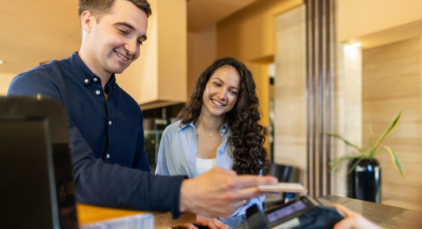 Man and woman paying in a hotel