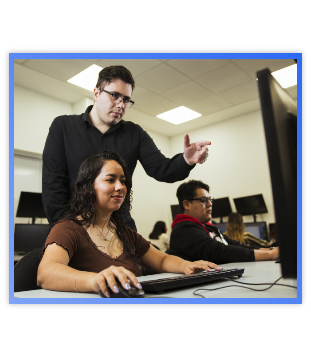 Man pointing at projector screen talking to a woman